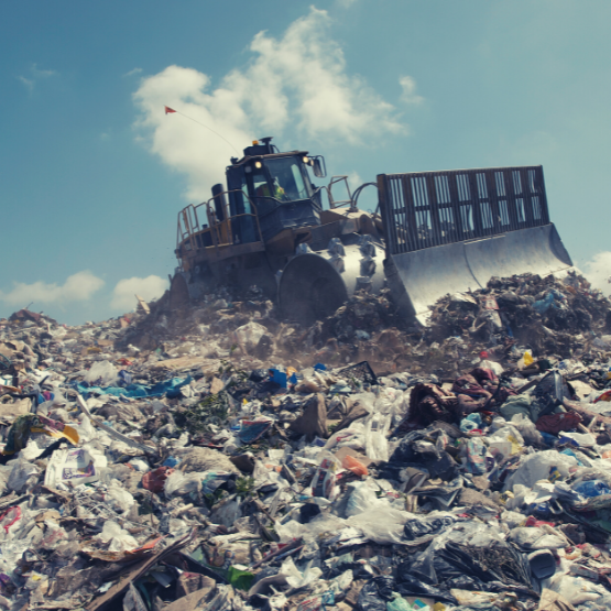 A bulldozer in a landfill