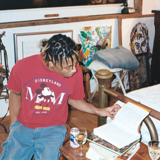 A man looking in a book for inspiration